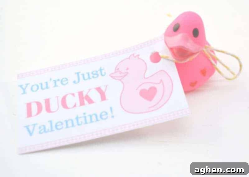 Mini rubber ducks with 'You're Just Ducky' Valentine cards tied to them with ribbon, ready to be handed out.