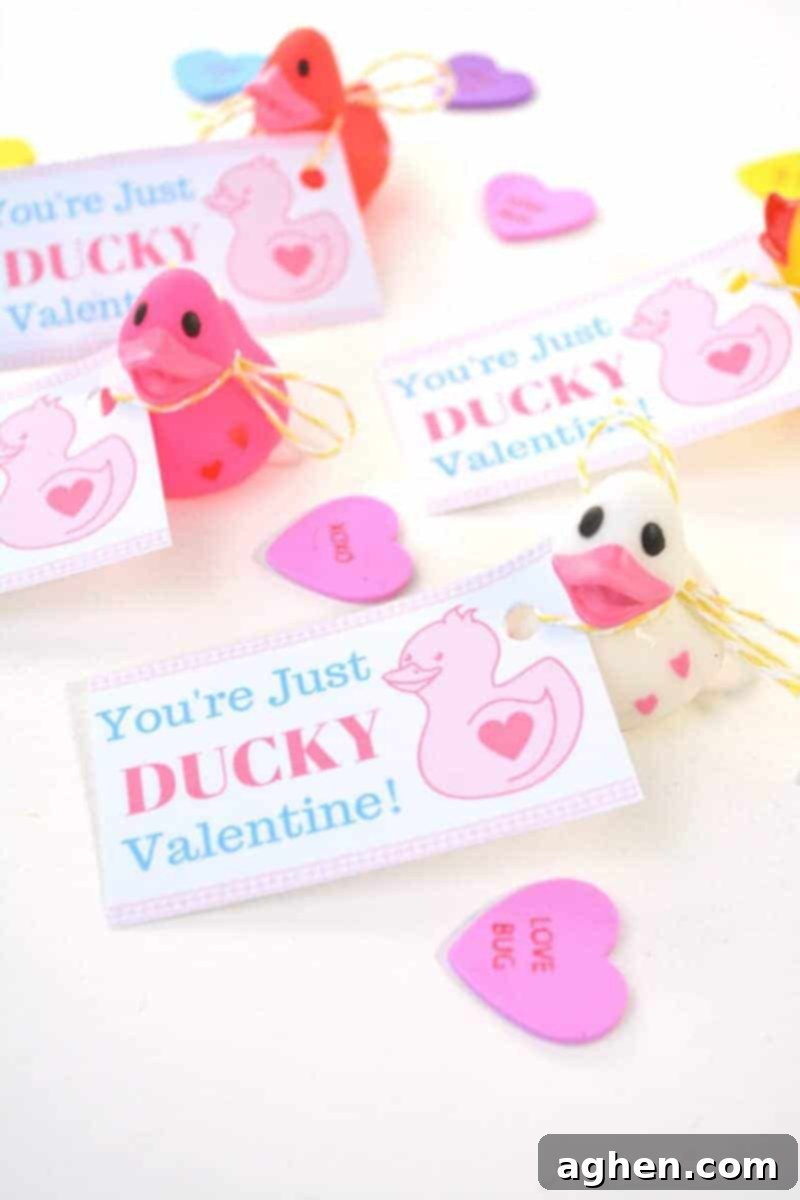 Close-up of a stack of 'You're Just Ducky' printable cards next to colorful mini rubber ducks, highlighting the craft components.