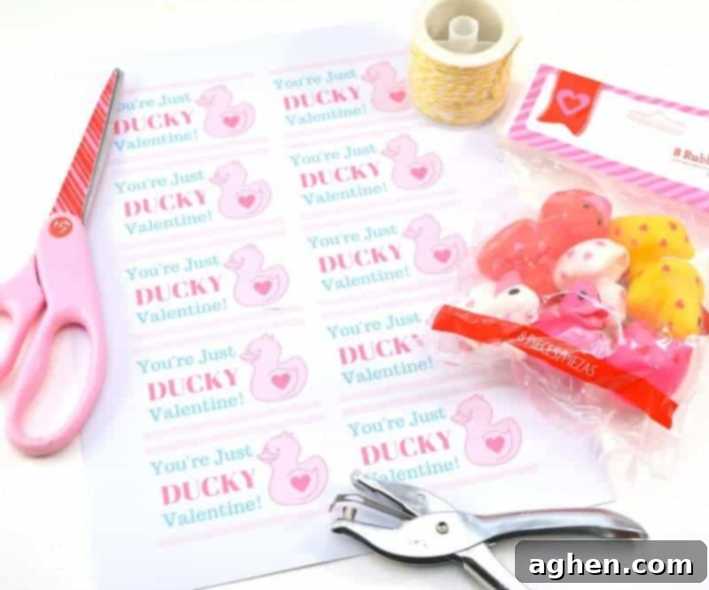 Crafting supplies laid out for the 'You're Just Ducky' Valentine project, including mini rubber ducks, ribbon, scissors, and printed cards.