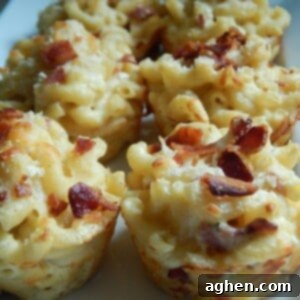 Cheesy Bacon Mac & Cheese Bites 2 Close-up of golden brown mac and cheese cups in a muffin tin.