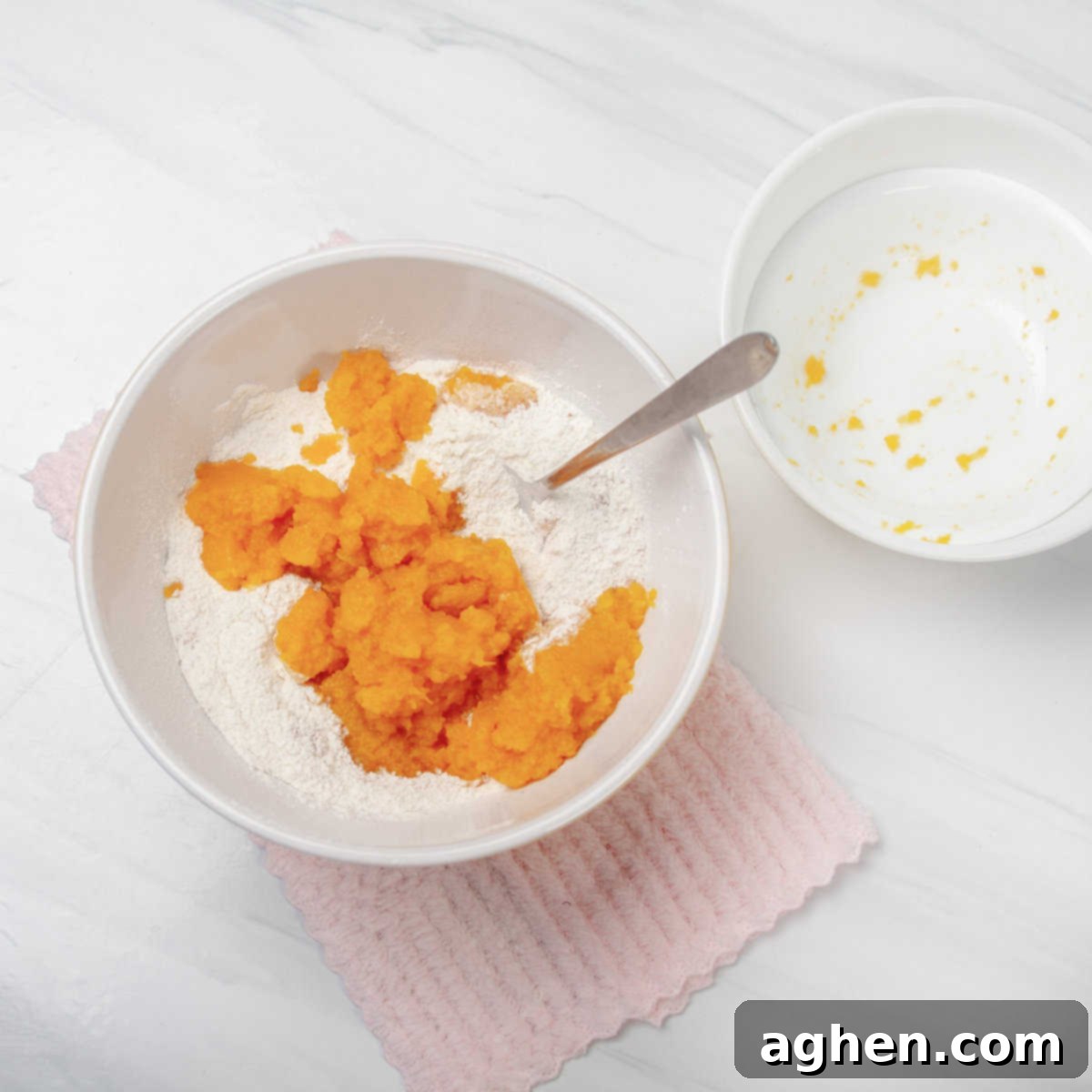Pumpkin cake mix and pumpkin puree combined in a bowl. 