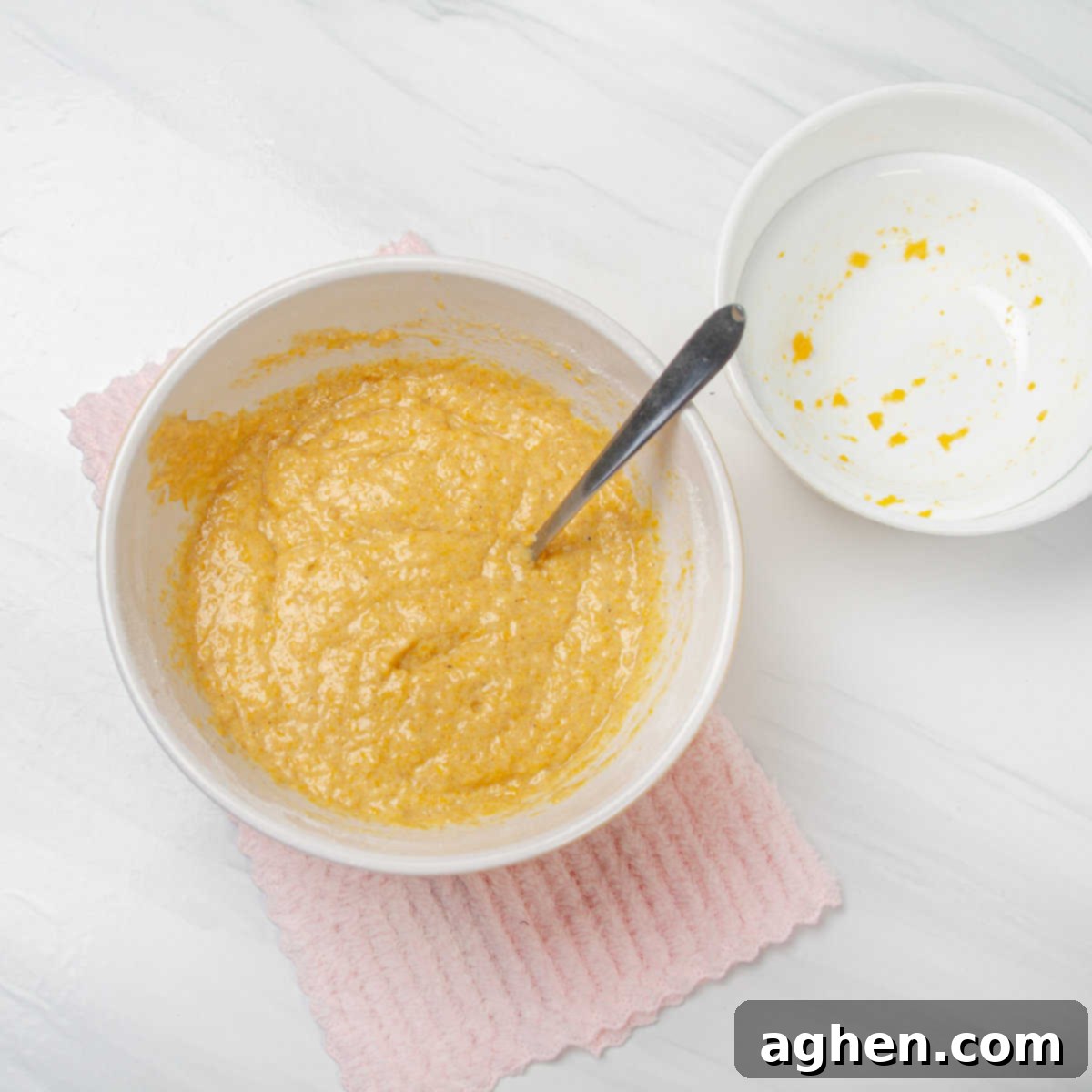 Mixture of pumpkin cake mix, puree, and water in a bowl. 
