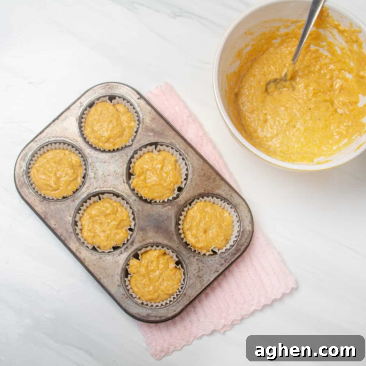 Raw muffin batter in muffin tins.