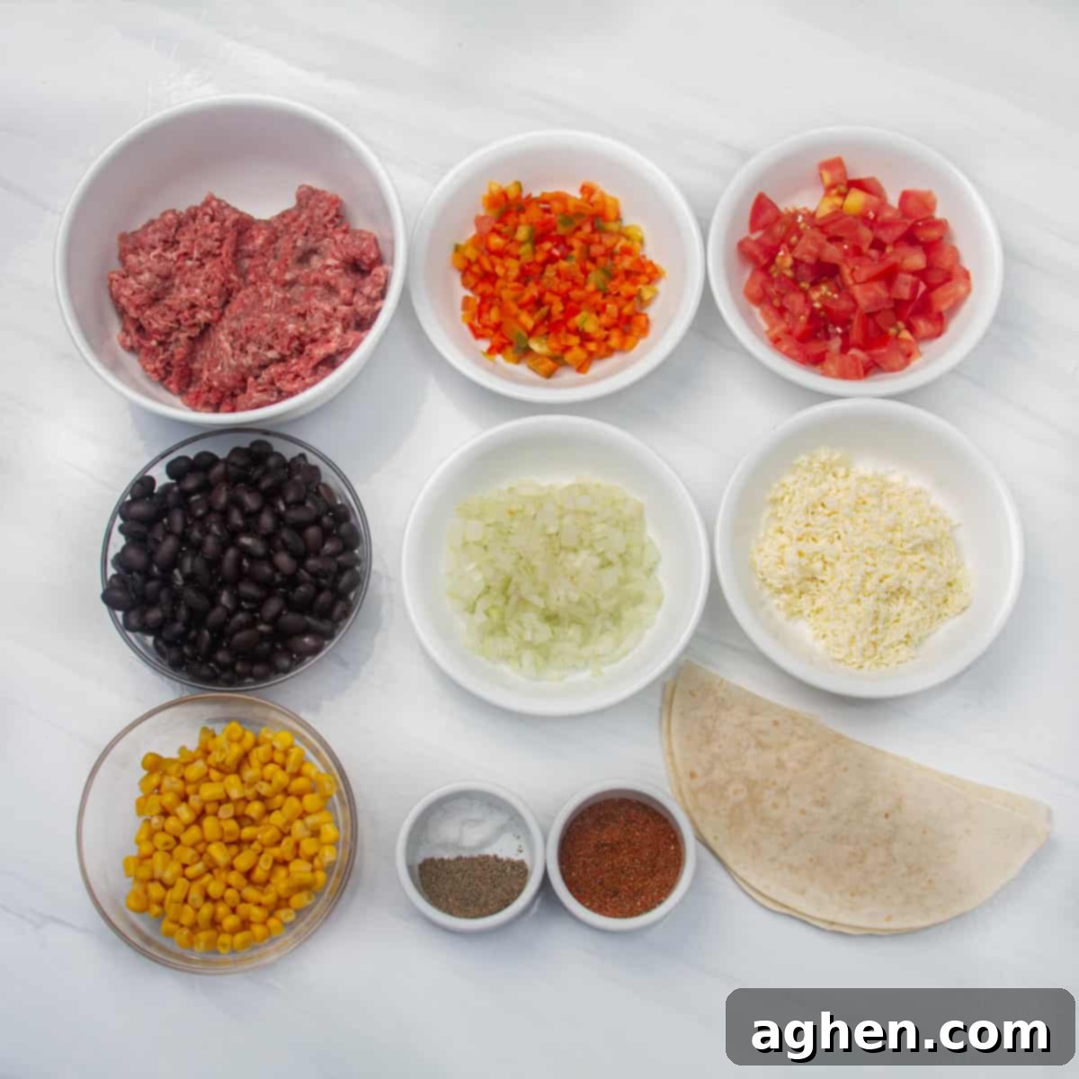 Simple Taco Casserole: Your Taco Night Game Changer 3 Ingredients of ground beef, taco seasoning, black beans, sweet corn, diced tomatoes, diced onions, chopped bell pepper, grated cheese, tortillas, and Greek yogurt in separate dishes.