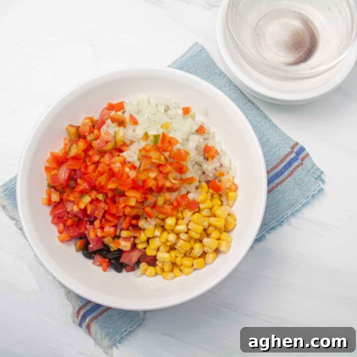 Simple Taco Casserole: Your Taco Night Game Changer 5 Drained beans, corn, diced tomatoes, chopped onions, and bell peppers combined in a bowl.