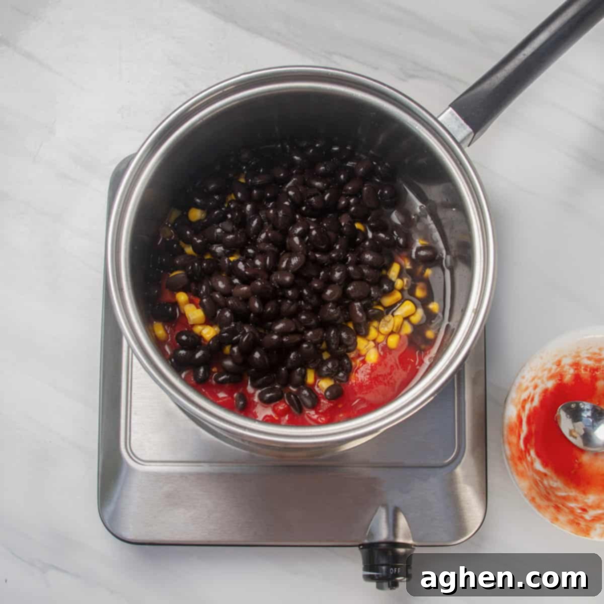 Speedy Skinny Chicken Tortilla Soup 5 Adding black beans and crushed tomatoes to the simmering aromatics in the pan.