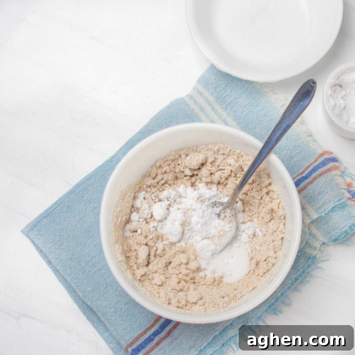 Sunshine Slice 3-Point Lemon Bars 4 Crust ingredients of oat flour, stevia, and coconut cream in a bow.