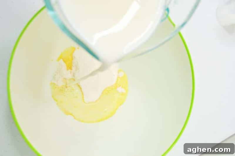 Step-by-step: Combining vanilla pudding mix and cold milk in a large bowl for St. Patrick's Day Parfaits.