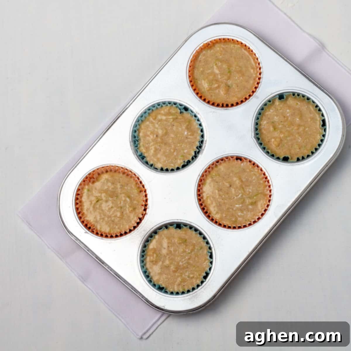Irresistible Holiday Cinnamon Muffins 6 All muffin batter ingredients poured into a muffin tin lined with paper liners.