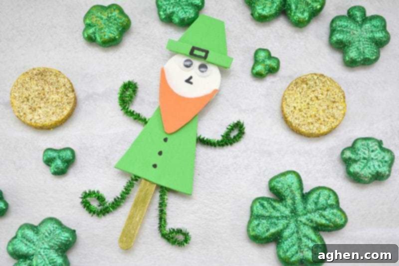 Completed popsicle stick leprechaun craft with a cheerful expression, perfect for St. Patrick's Day decorations or imaginative play with kids.