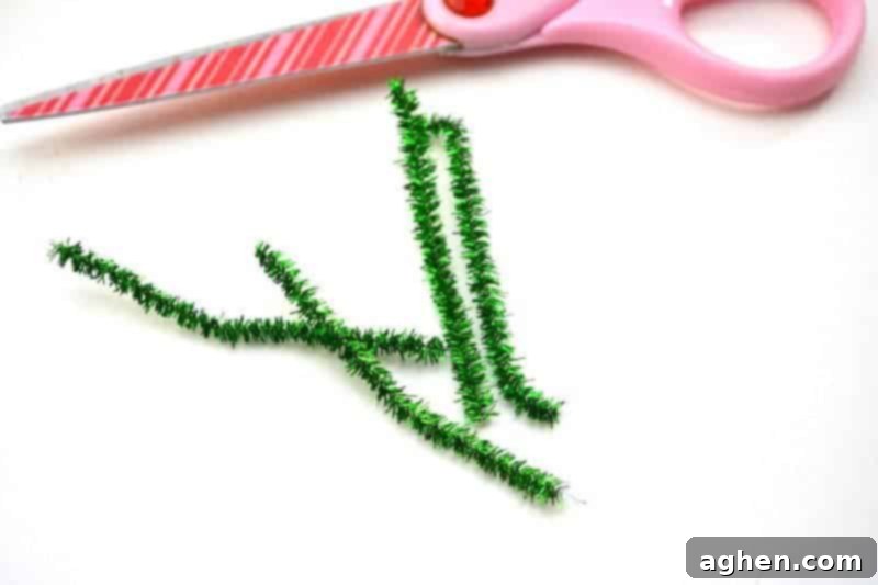 Step-by-step instruction: Cutting a green pipe cleaner into four equal pieces and curling the ends to form small circles for the leprechaun's arms and legs.
