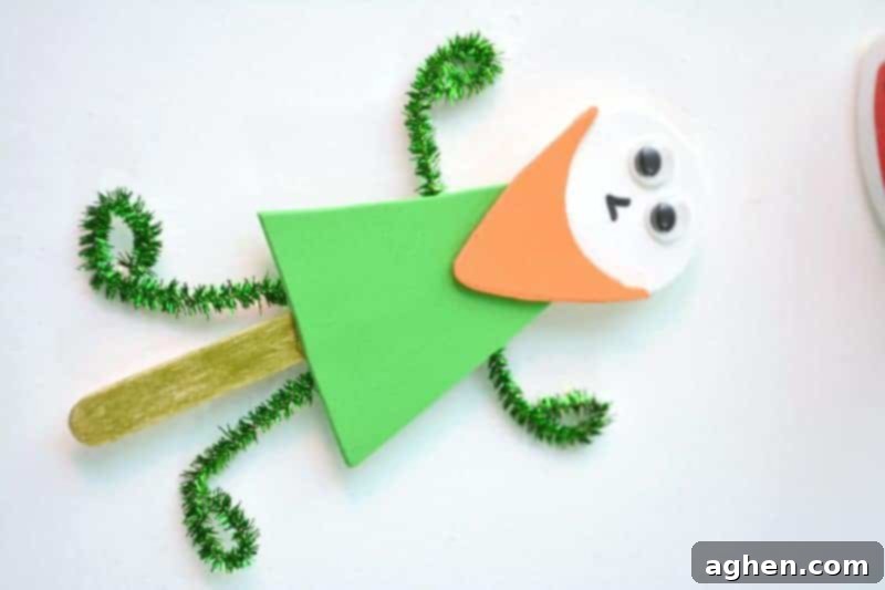 Step-by-step instruction: Gluing green pipe cleaners to the back of the popsicle stick, forming the leprechaun's arms and legs, making it a movable puppet.