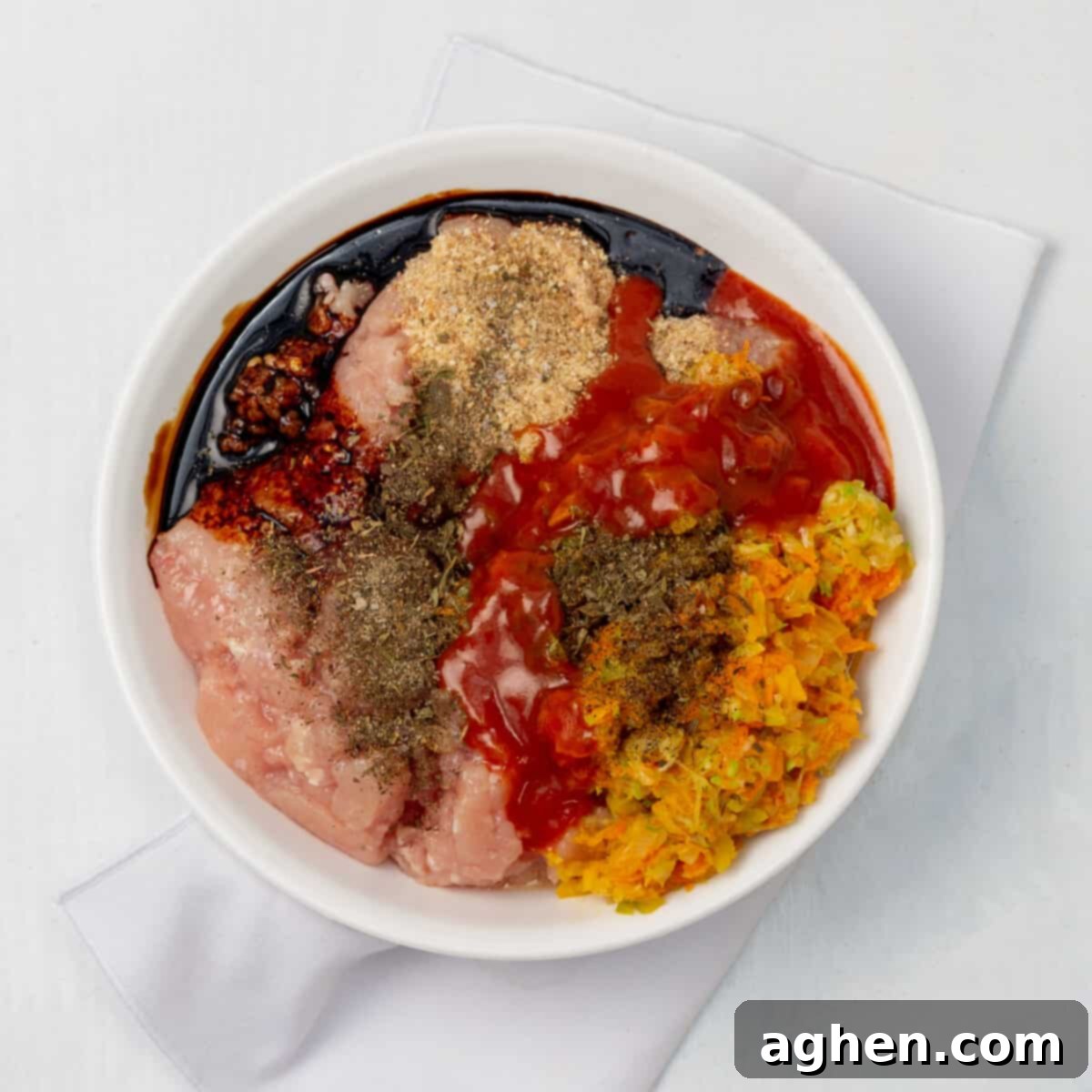 Easy Guilt-Free Turkey Meatloaf 5 Cooked veggies, meat, and seasonings combined in a bowl.