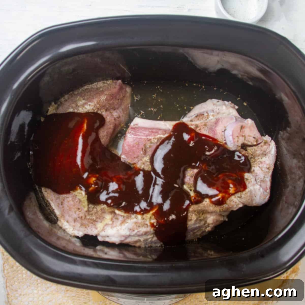 Coat the meat with a mixture of BBQ sauce, vinegar, and chicken broth.