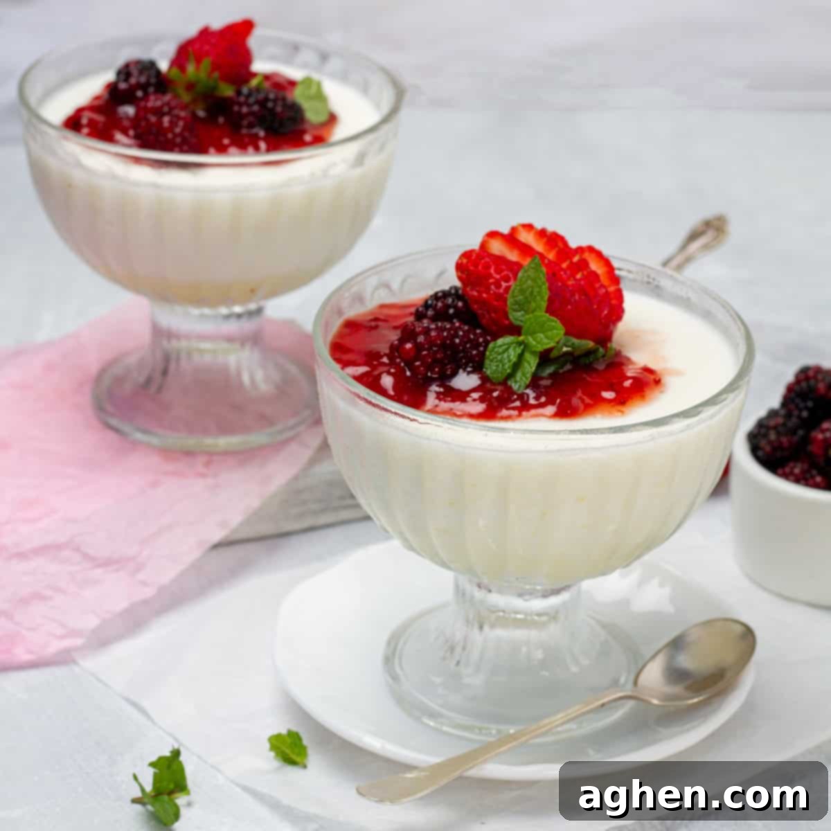 Your 1-Point Passport to Italian Countryside Dreams 2 Rich and creamy panna cotta in two dishes, topped with fresh berries and mint.