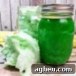 Small image of homemade Green Cotton Candy Moonshine in a jar.