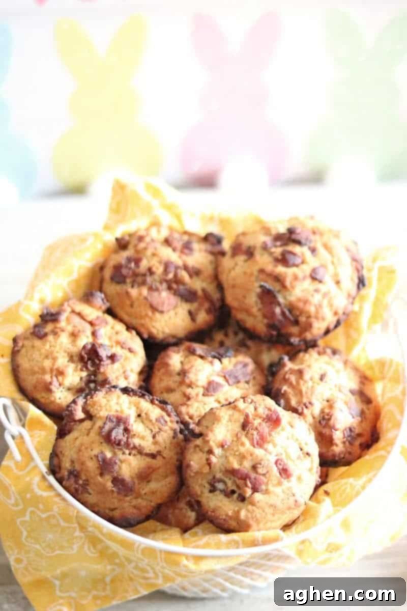 A charming basket filled with golden-brown Savory Bacon Muffins, ready to be enjoyed as a delightful breakfast or brunch.