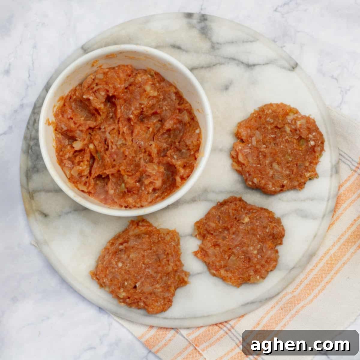 Seasoned raw chicken shaped into patties.