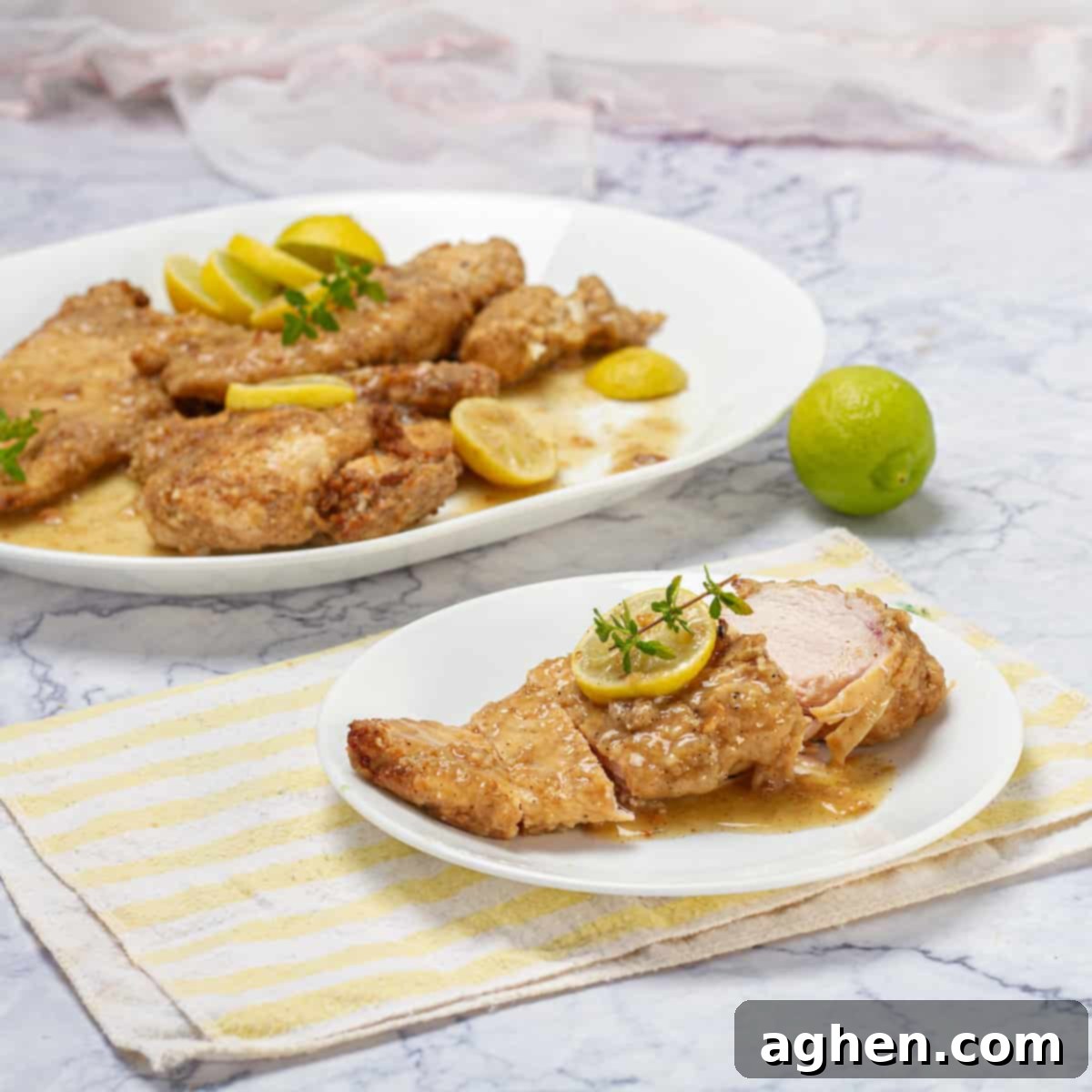Flavorful breaded chicken francese garnished with fresh lemon.