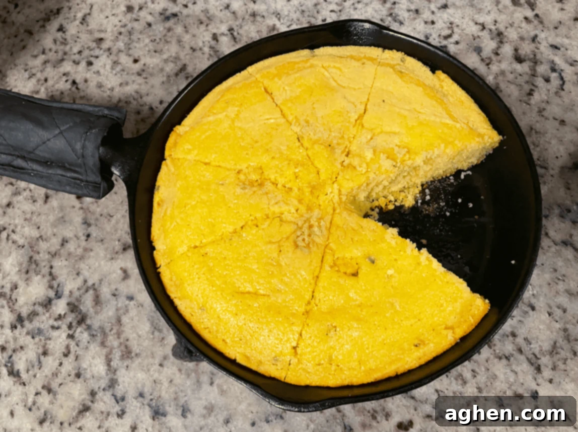 cornbread in cast iron skillet with one piece missing