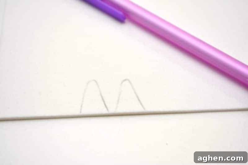 Step 2: Draw smaller versions of the ear shape onto white craft foam for the inner ears. Ensure they fit inside the pink shapes.