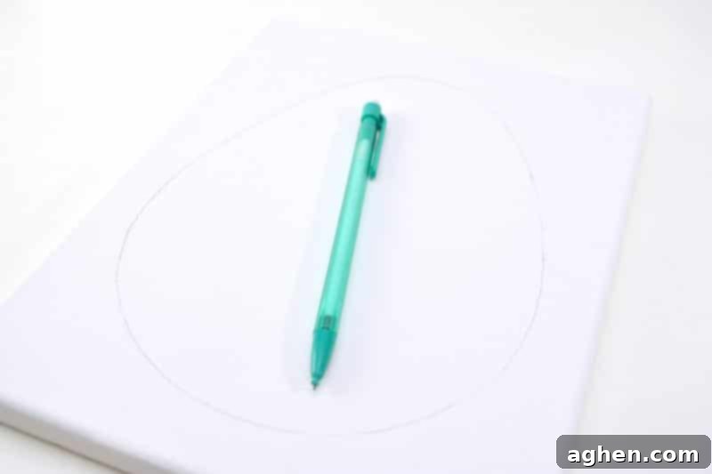 Lightly outlining an Easter egg shape on a white canvas with a pencil.
