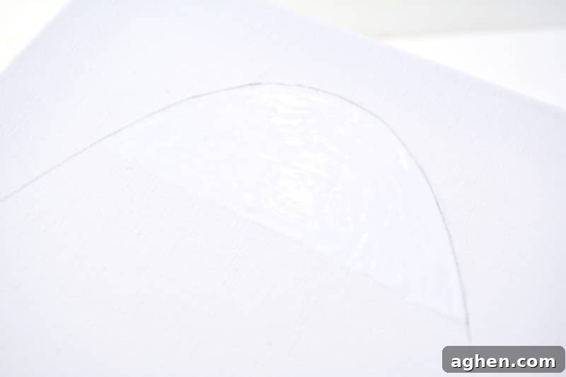 Applying white school glue to a section of the outlined Easter egg on canvas.