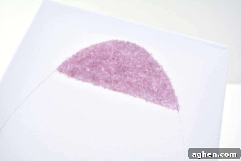 Sprinkling colorful salt glitter onto the glued section of the Easter egg canvas.