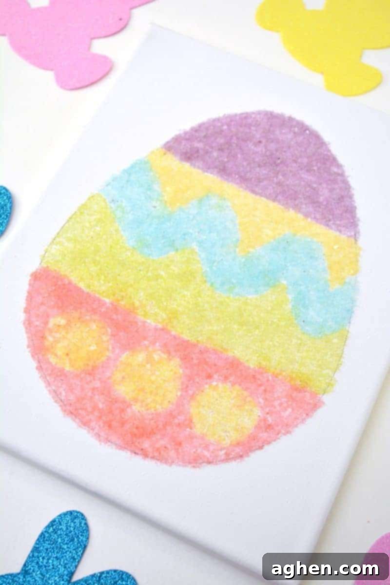 A finished vibrant Easter egg canvas art piece made with homemade salt glitter.