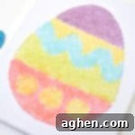 Completed colorful salt glitter Easter egg canvas art project.