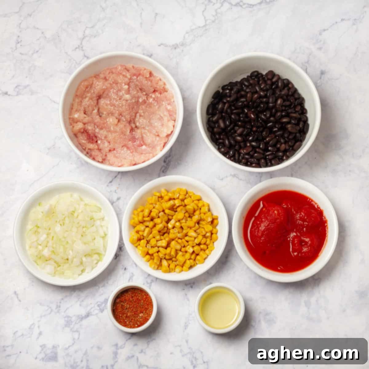 Irresistible Zero Point Turkey Chili 3 Ingredients for healthy turkey chili laid out: ground turkey, canned black beans, diced tomatoes, corn, chopped onion, olive oil, and taco seasoning.