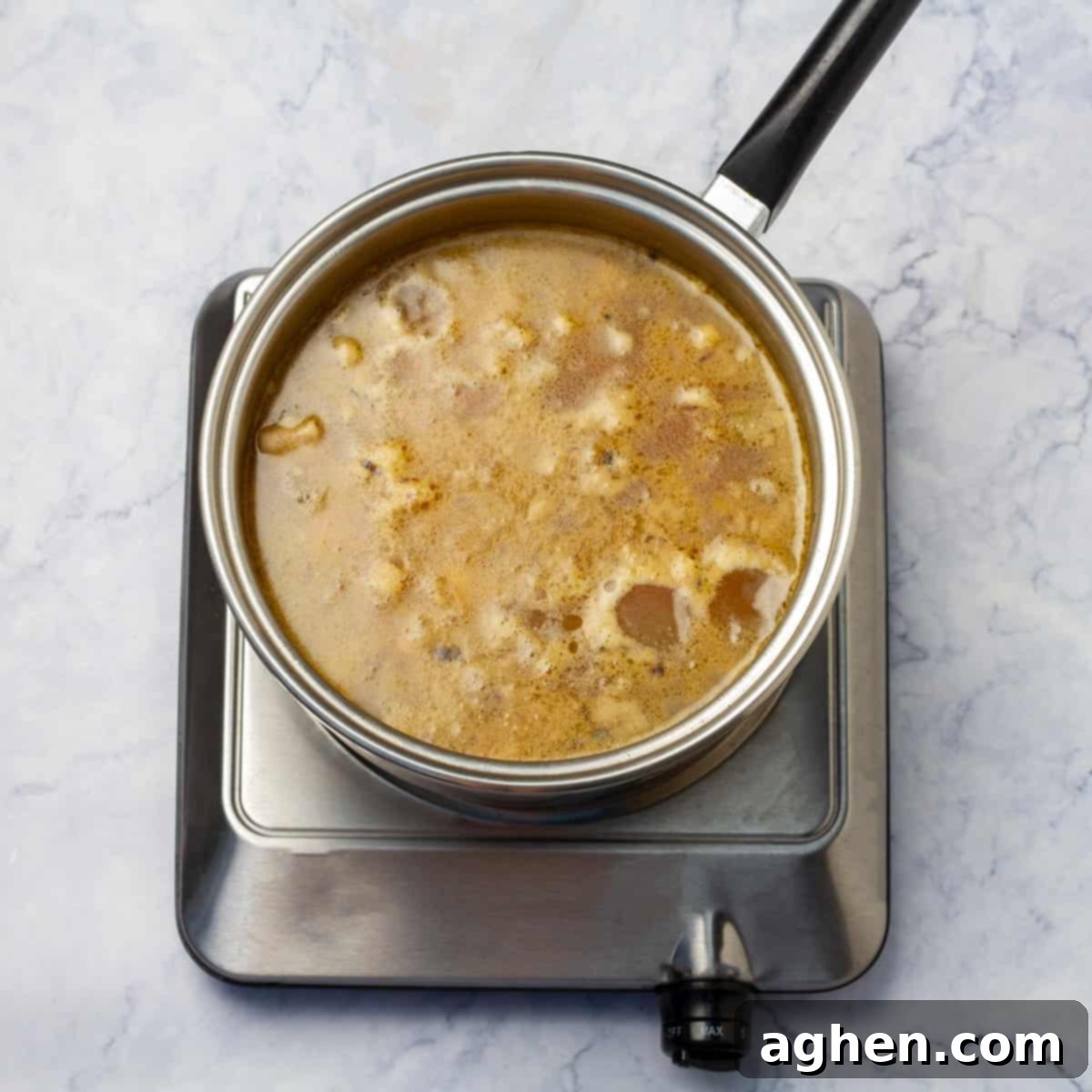 All chicken and barley soup ingredients simmering together in savory broth, creating a hearty meal.