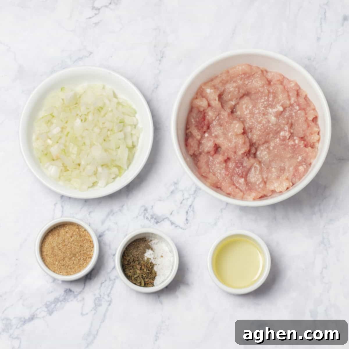 Raw ingredients of ground turkey, chopped onion, and spices in separate dishes.