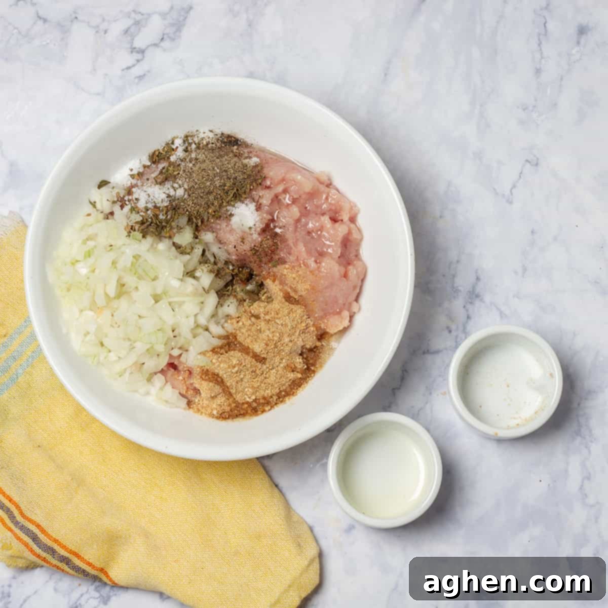 Seasoning the ground turkey with spices and raw diced onion.