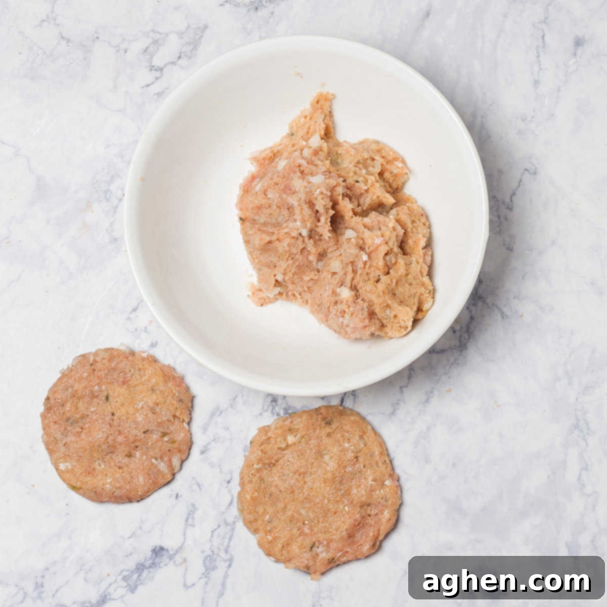 Shaping the seasoned ground turkey mixture into patties.