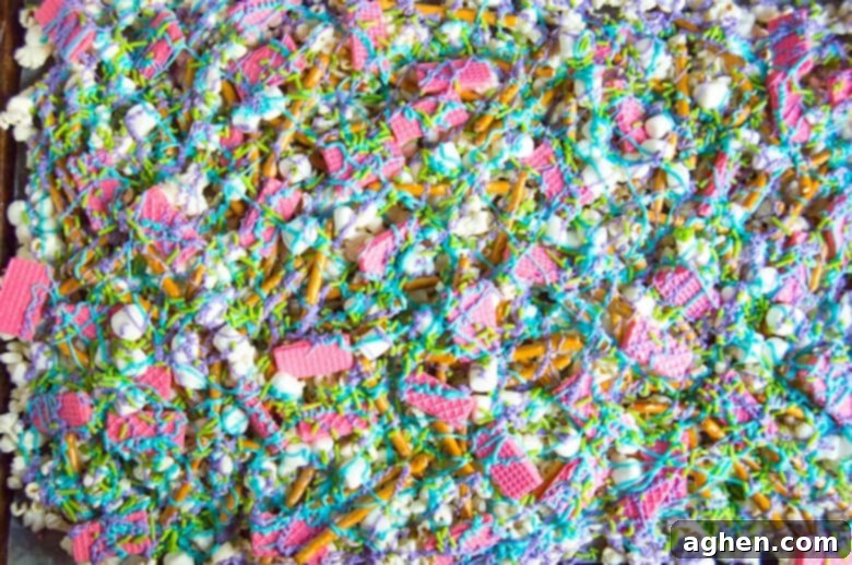 Finished Bunny Bait snack mix with blue and purple chocolate drizzle and festive sprinkles.
