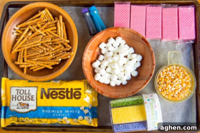 Ingredients for Bunny Bait: popcorn, pretzel sticks, strawberry wafers, white chocolate chips, blue and purple food coloring, mini marshmallows, and sprinkles.