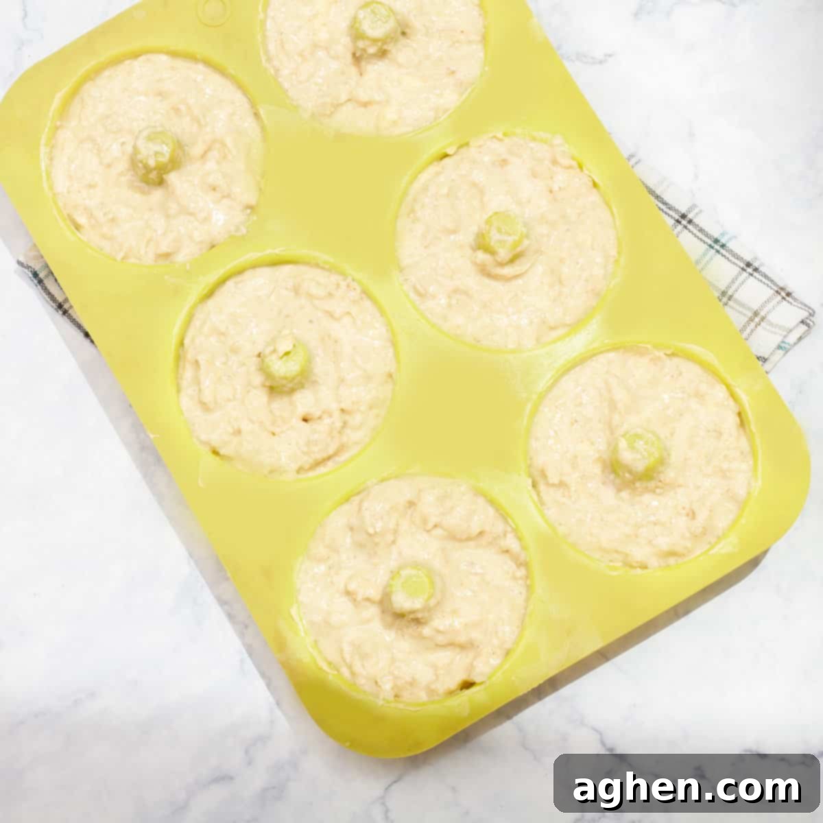 Apple Cider Donut dough neatly spooned into a donut baking mold, ready to be baked.
