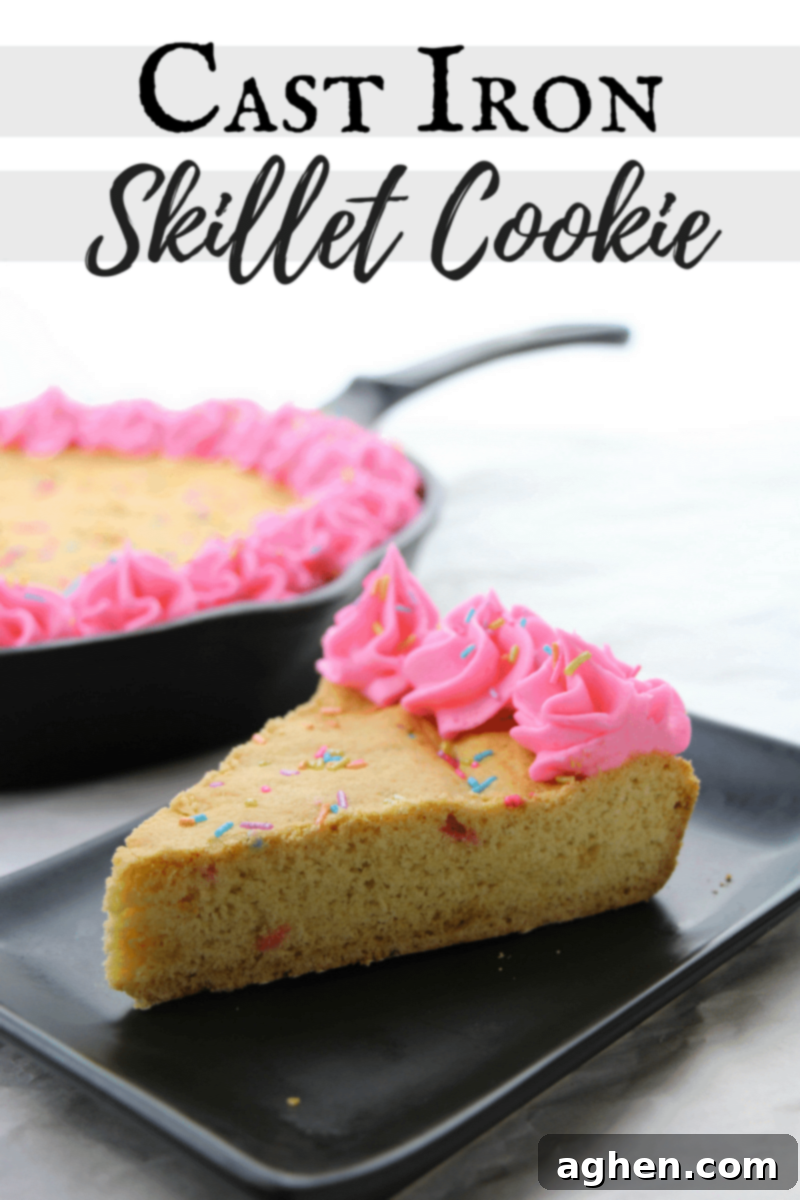 A Pinterest-friendly vertical image of the giant cast iron skillet cookie, beautifully decorated with rainbow sprinkles and pink frosting, perfect for saving to your dessert boards.
