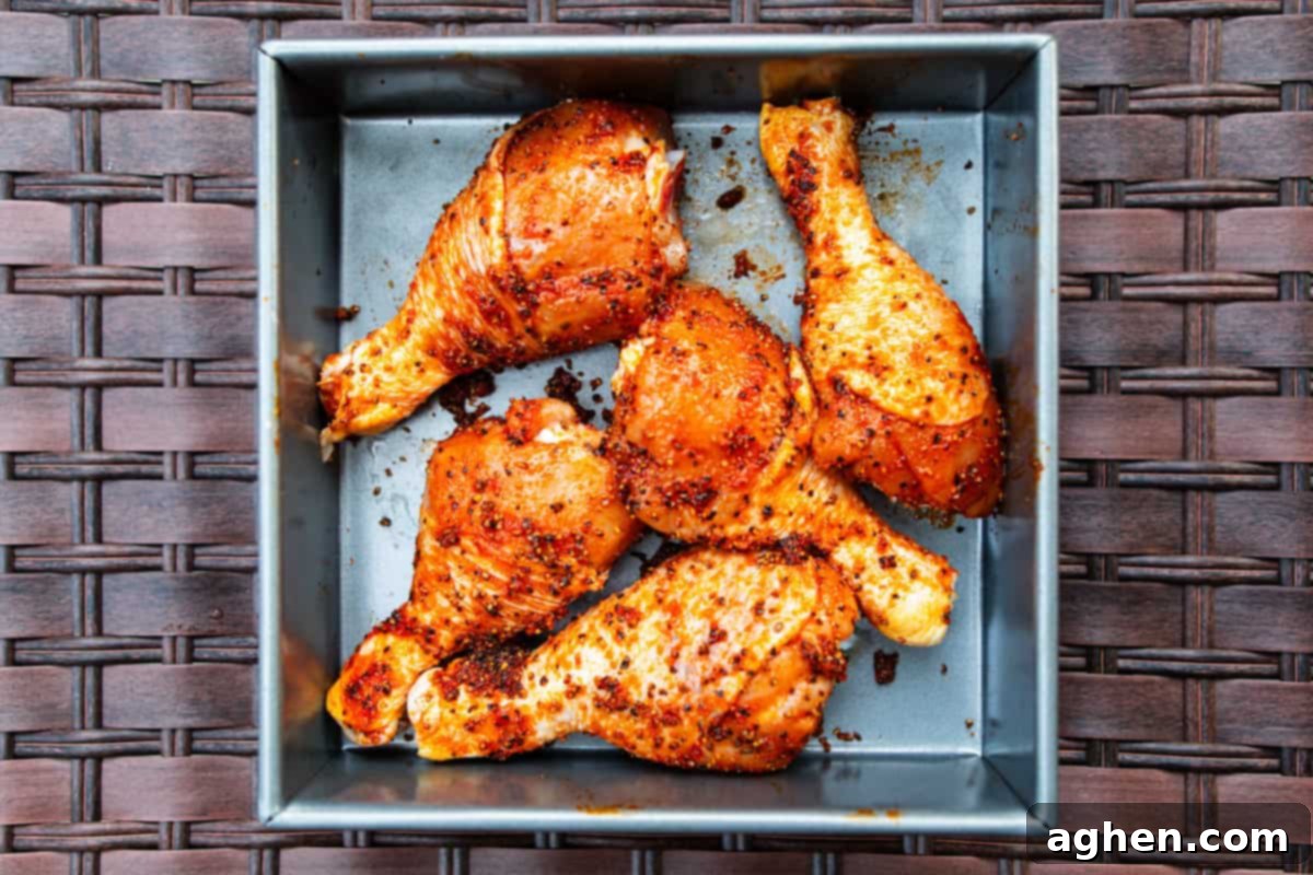 five chicken legs with dry rub in a pan