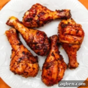 five smoked chicken legs on a white plate