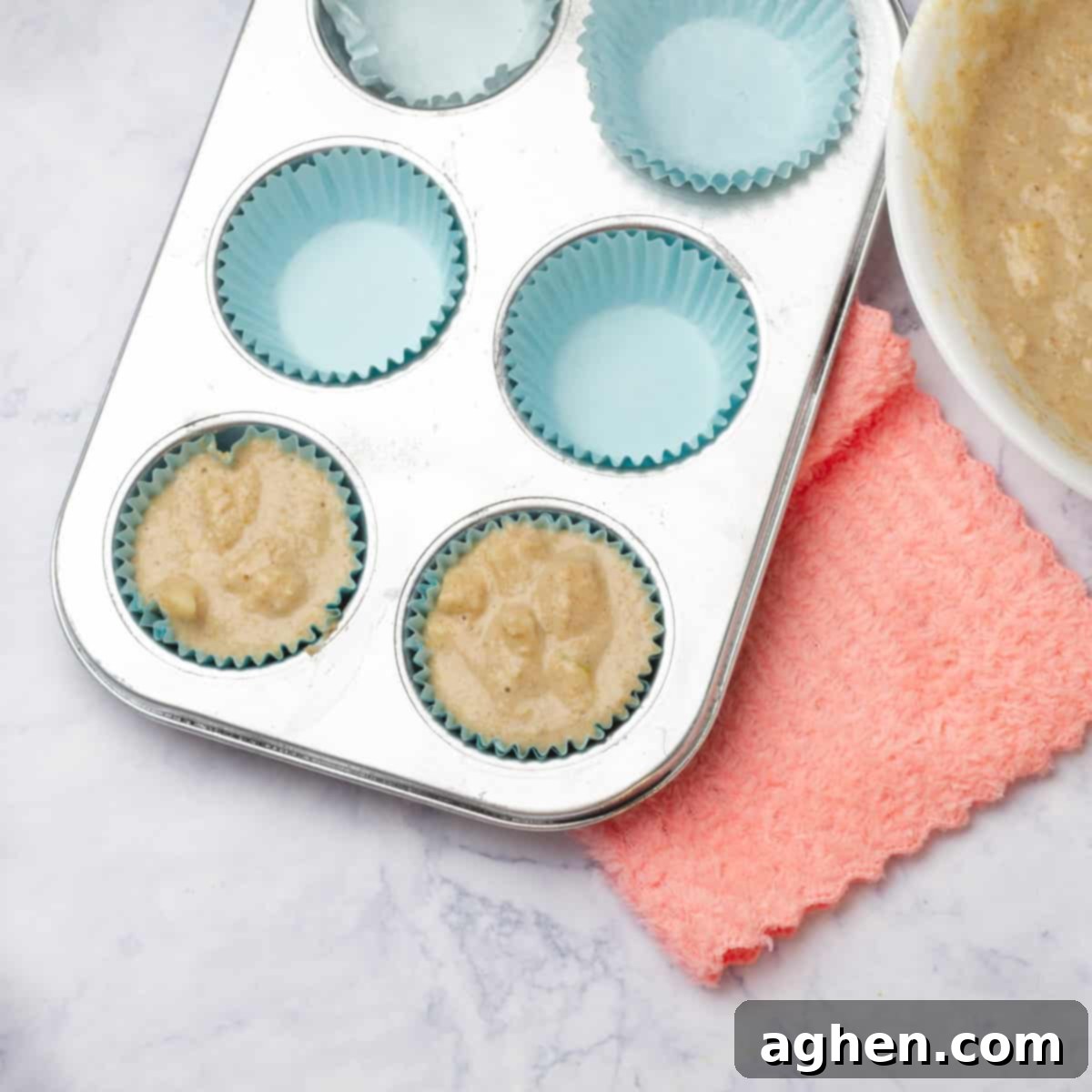 Guilt-Free Weight Watchers Apple Muffins 6 Apple muffin batter in lined muffin tins, ready to bake.