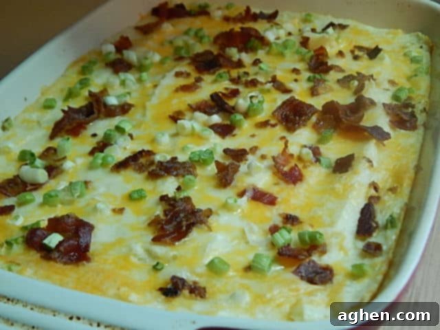 Guilt-Free Thanksgiving: 15 Weight Watchers Casserole Recipes 3 Loaded baked potato casserole in a vibrant red baking dish, topped with cheese, bacon, and green onions