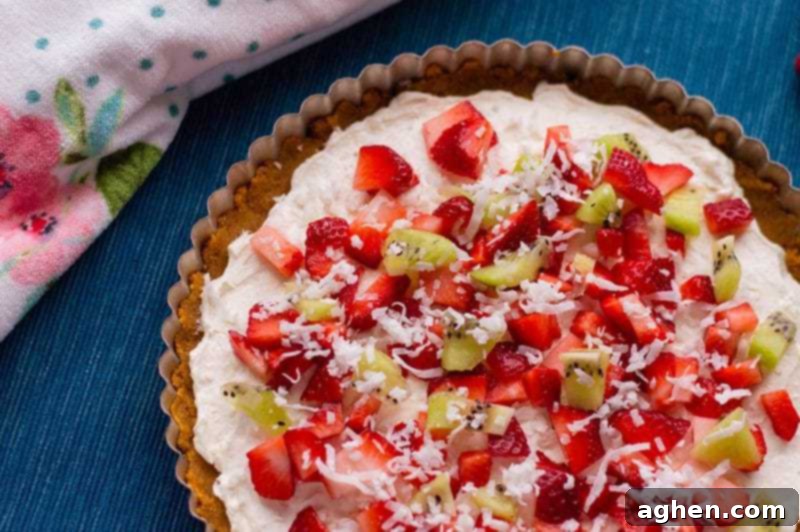 No-bake fruit pizza with a smooth cream cheese filling, chilling in the refrigerator before adding fruit.