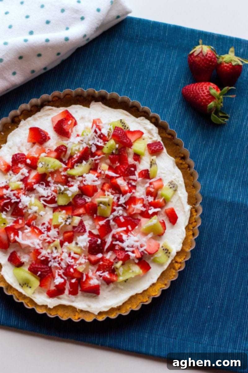 A vibrant no-bake fruit pizza topped with beautifully arranged fresh fruit, ready to be served.