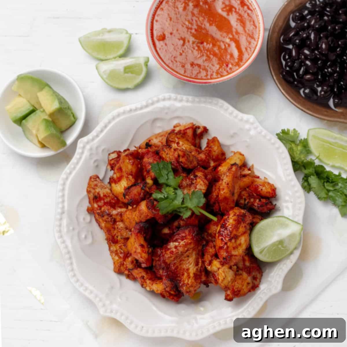 Grilled Chicken al Pastor served with fresh cilantro and lime wedges