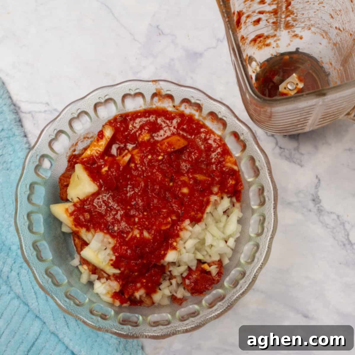 Chili pineapple marinade being poured over chicken and onion in a bowl