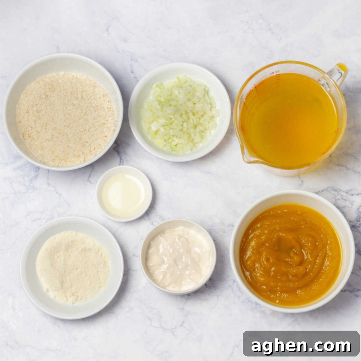 Velvety Pumpkin Risotto 3 Pumpkin Risotto ingredients of arborio rice, pumpkin puree, onion, broth, Greek yogurt, olive oil, and parmesan cheese in separate dishes.