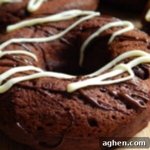 Freshly baked triple chocolate brownie donuts on a cooling rack