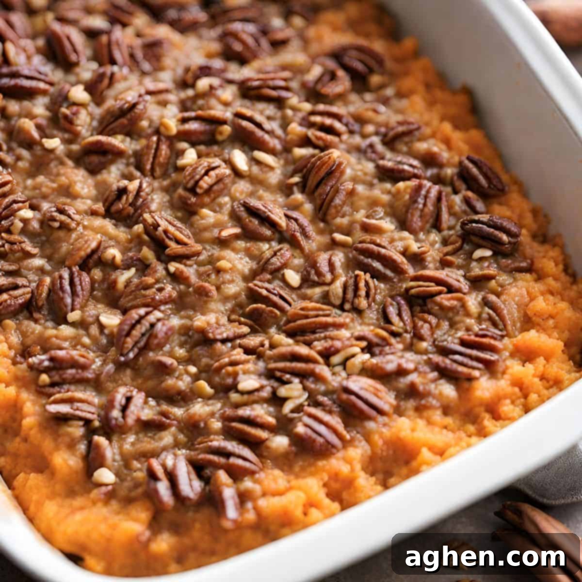 Bourbon infused sweet potato casserole in white dish, ready to be served